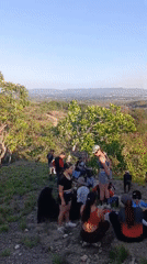 Mountain biking group gathers at hilltop cross in Tinaquillo