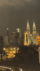 Kuala Lumpur at night, Petronas Towers glowing over the city