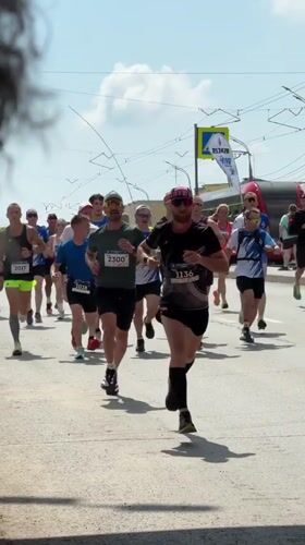 Marathon runners race through Izhevsk streets on sunny morning