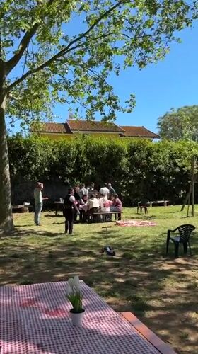 Backyard gathering captured on sunny afternoon in Aprilia, Italy