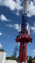 Sunny afternoon at Saint Petersburg amusement park with rides and crowds