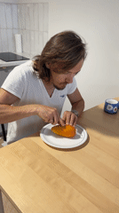 Man cuts mango at table in Izhevsk