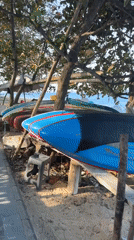 Colorful surfboard on a Bali beach, ready for the day.
