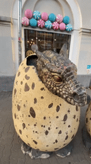 Street musician performs near hotel statue in Kazan square