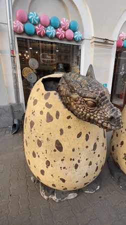 Street musician performs near hotel statue in Kazan square