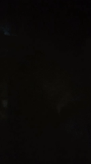 Night sky flashes and drifting fog in low-light conditions