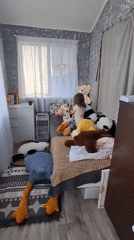 Toddler plays with panda stuffed animals during morning playtime