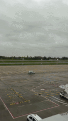 Commercial aircraft lands at Charleroi Airport during rainy weather