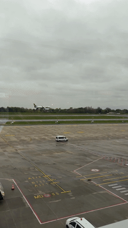 Commercial aircraft lands at Charleroi Airport during rainy weather