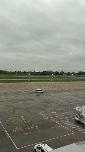 Commercial aircraft lands at Charleroi Airport during rainy weather
