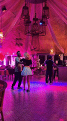 Couples slow dance in colorful restaurant venue in Pattaya