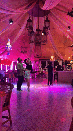 Couples slow dance in colorful restaurant venue in Pattaya