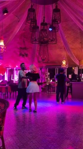 Couples slow dance in colorful restaurant venue in Pattaya