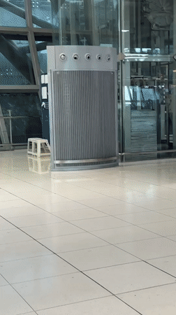 Flight crew moving through a Thai airport terminal with luggage