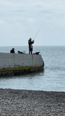 Overcast beach day brings windsurfers, sunbathers to Sochi coast
