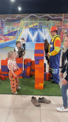 Children build with giant blocks in mall playground