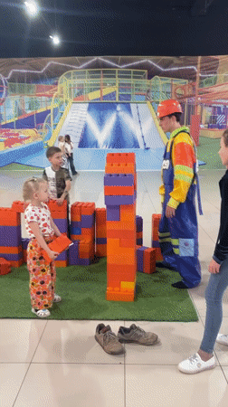 Children build with giant blocks in mall playground