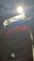 Russian flag waves in heavy snowfall in Murino