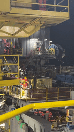Offshore drilling rig operations documented at night in Italian waters