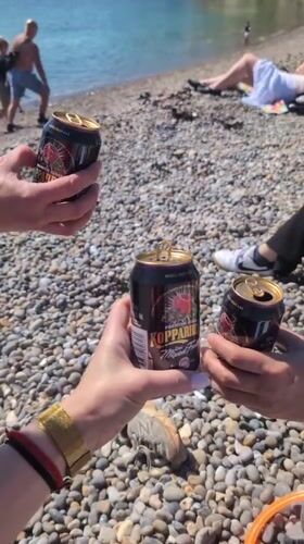 Beach gathering with drinks and water sports in East Devon