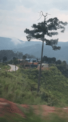 Vehicle travels through lush mountains in Tu Póh, Vietnam