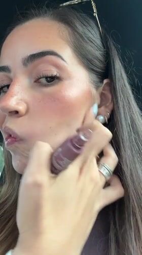 Woman applies makeup in parked car on Puebla street