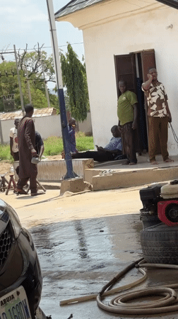 Daily commerce and car services documented in Nigerian village