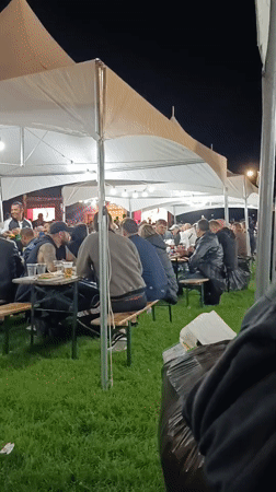Evening outdoor event draws attendees to tented gathering