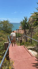 Tourist walks coastal paths near Benalmádena restaurant overlook