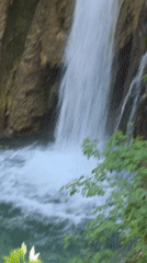 Waterfall documented at Bulgarian monastery amid spring foliage