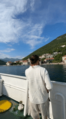 Couple documents scenic ferry ride through Bay of Kotor