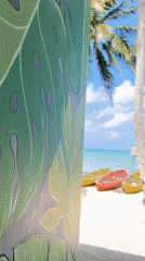 Palm-lined beach and leaf mural at Legonipah, Indonesia
