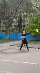 Fire dancer performs with poi in Rostov-on-Don public square