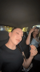 Two women travel by car through Giza at night