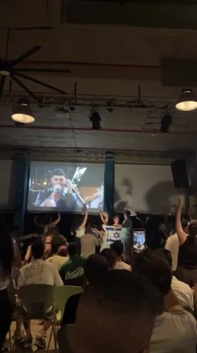 Tel Aviv crowd watches male performer on venue projection screen
