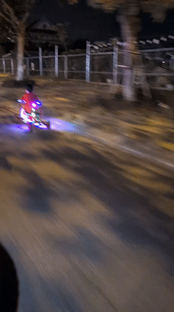 Colorful light-up three-wheeler rolling through Đà Nẵng