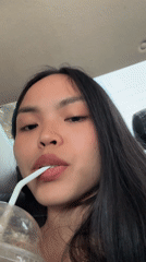 Woman drinks from cup in car, Davao City