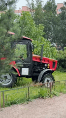 Tractor mows park grass alongside blooming roses in Saint Petersburg