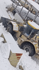 Heavy machinery operates in snowy conditions at Russian industrial site