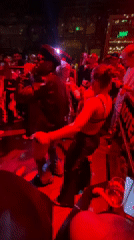 Nightclub dancing scene captured in red-lit Moscow venue