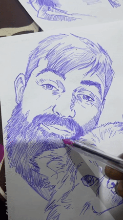 Live ballpoint portrait sketching session in Abuja, referencing a laptop photo