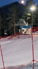 Night ski lift operation captured at forest resort