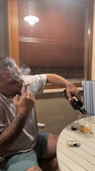 Man enjoys evening drink and cigarette on Velingrad balcony
