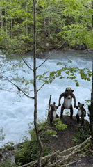 Tourist poses with bear statues at Abkhazia waterfall site