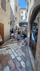 Tourists explore historic Kotor, Montenegro on summer afternoon