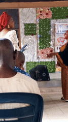 Church service with speakers and children at Nigerian Baptist church