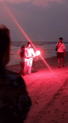 Couple enjoys sparklers on Mandrem beach at dusk