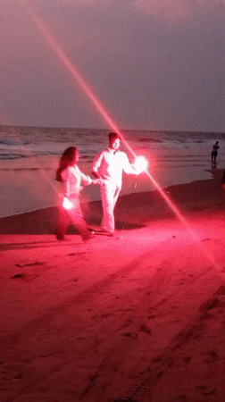 Couple enjoys sparklers on Mandrem beach at dusk