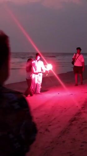 Couple enjoys sparklers on Mandrem beach at dusk