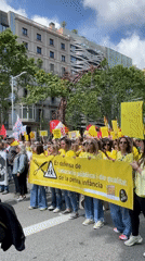 Barcelona education protesters march in yellow shirts defending public schools
